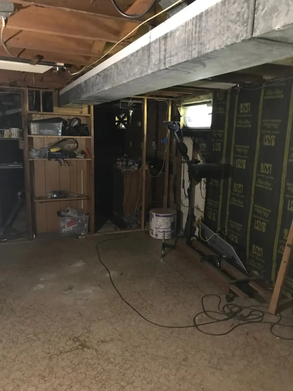 Selling a fire-damaged house in Smithtown: basement with open framing and exposed insulation