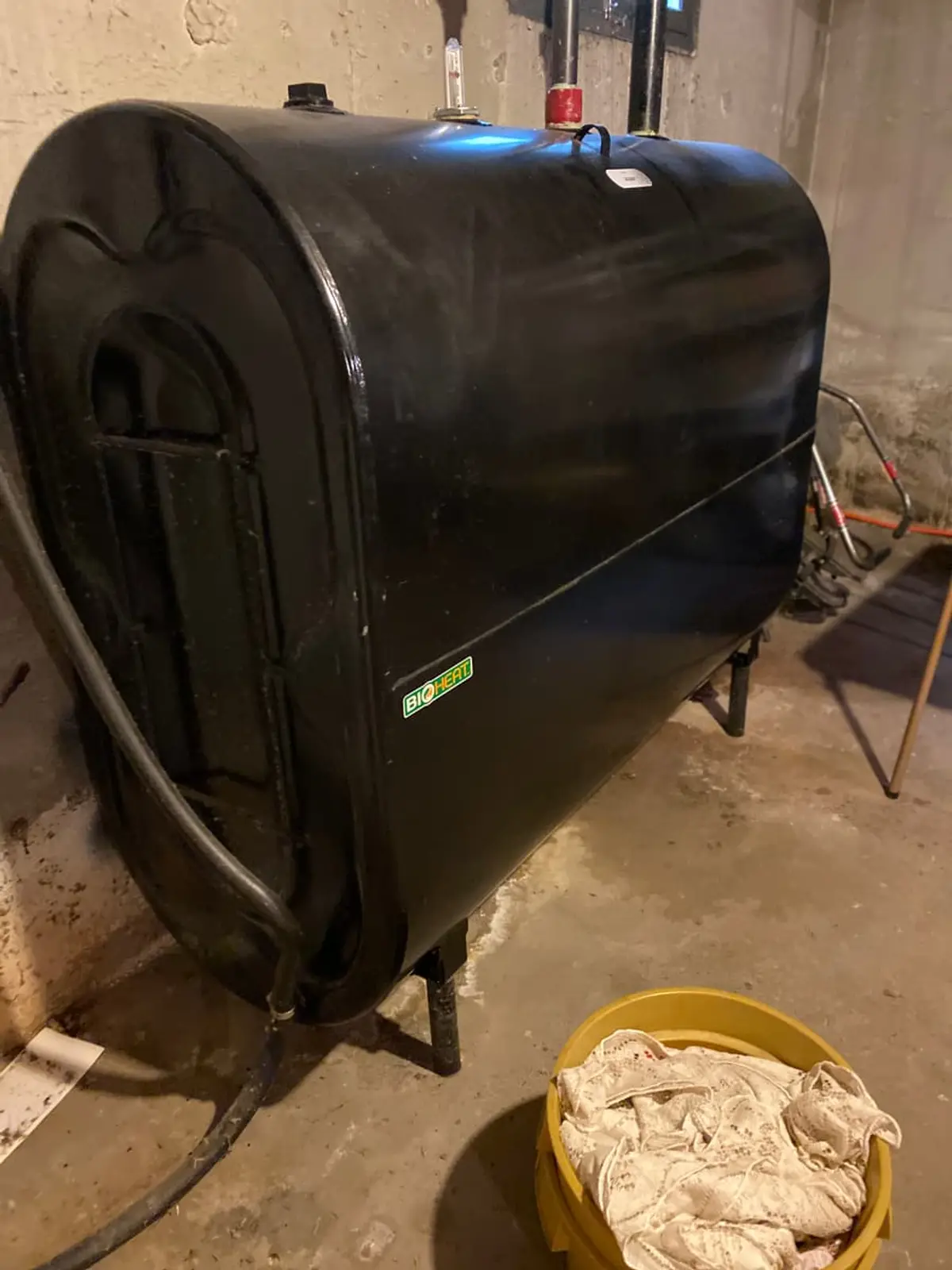 Selling a house with an oil tank in Smithtown: black oil tank against the basement wall