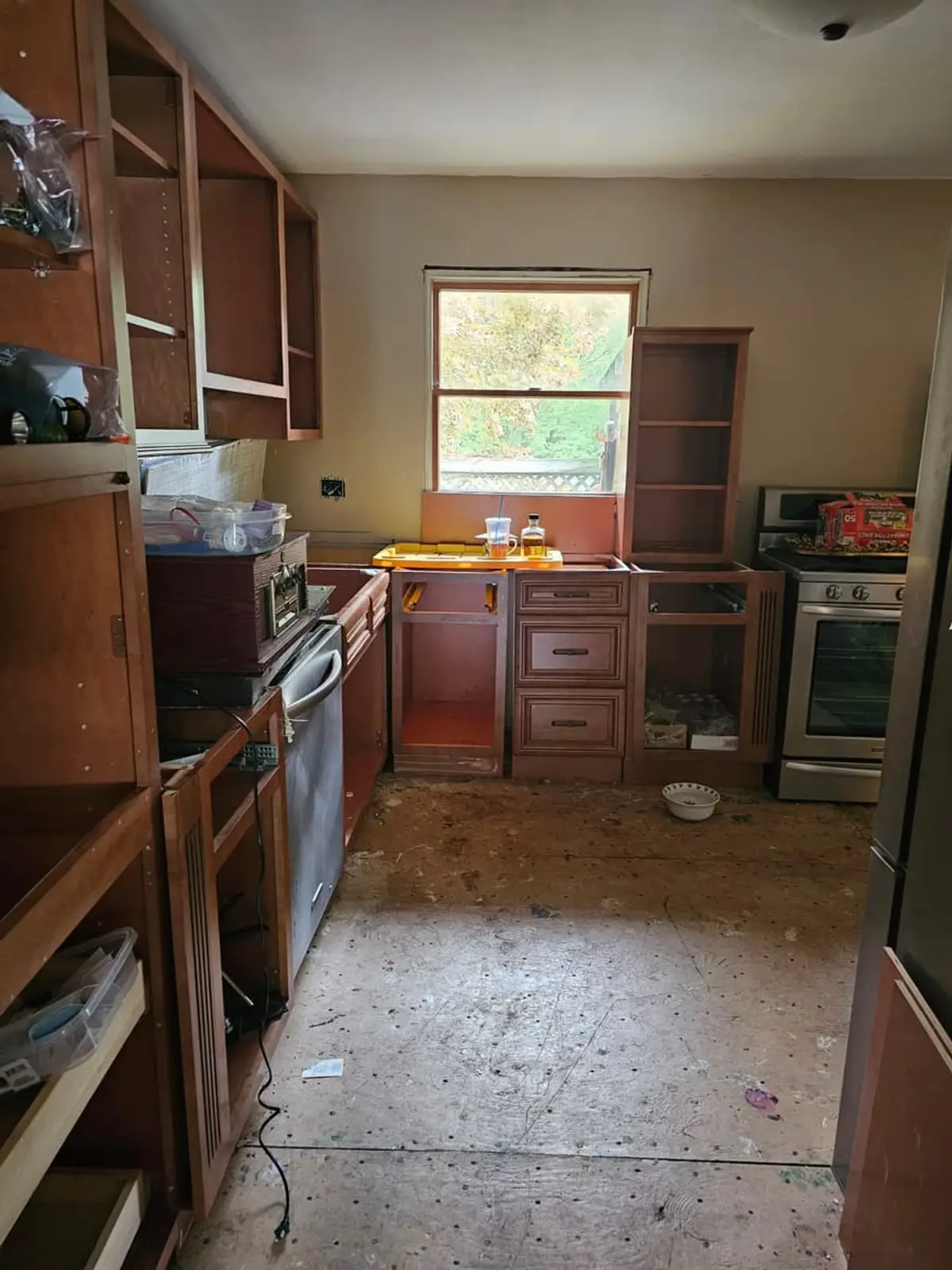Selling a house with foundation problems in Smithtown: kitchen with missing cabinet doors and bare subfloor