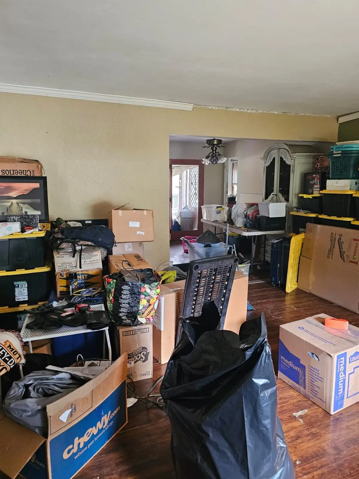 Selling a house during a divorce in Smithtown: living room packed with boxes and storage bins