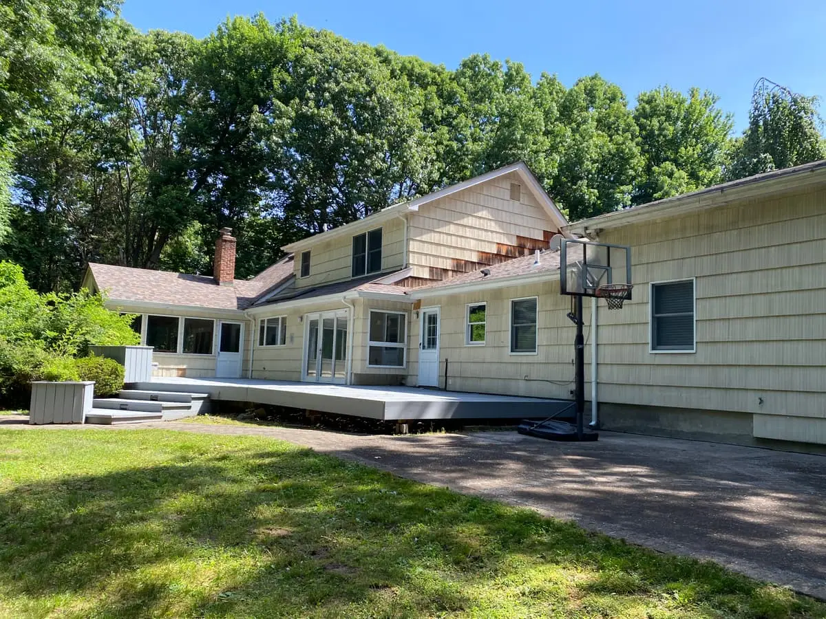Long rear deck across a shingled ranch, Smithtown, NY