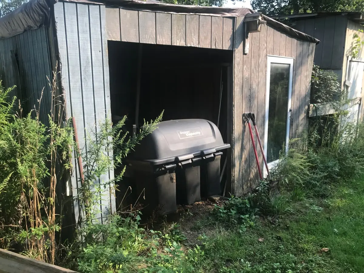 Selling a house with a failed cesspool in Smithtown: sagging wood shed with an open bay